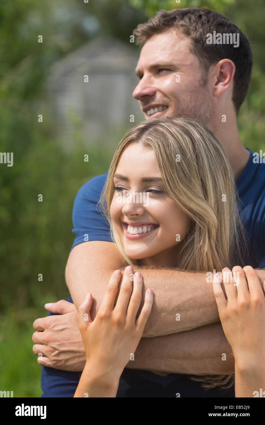 Cute couple smiling and hugging Stock Photo - Alamy
