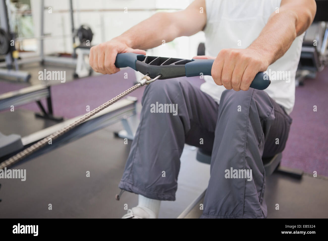 Fit man working out on rowing machine Stock Photo