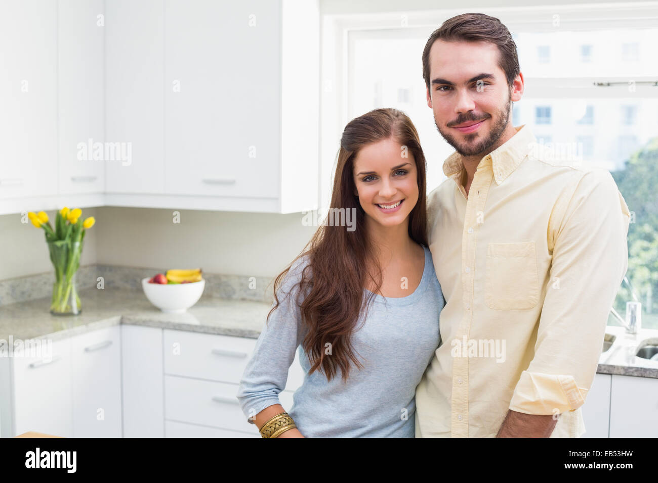 Young couple smiling at the camera Stock Photo - Alamy