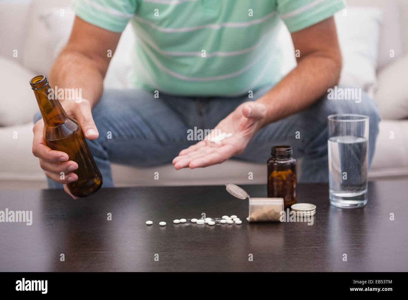 Man mixing beer with his medicine Stock Photo Alamy