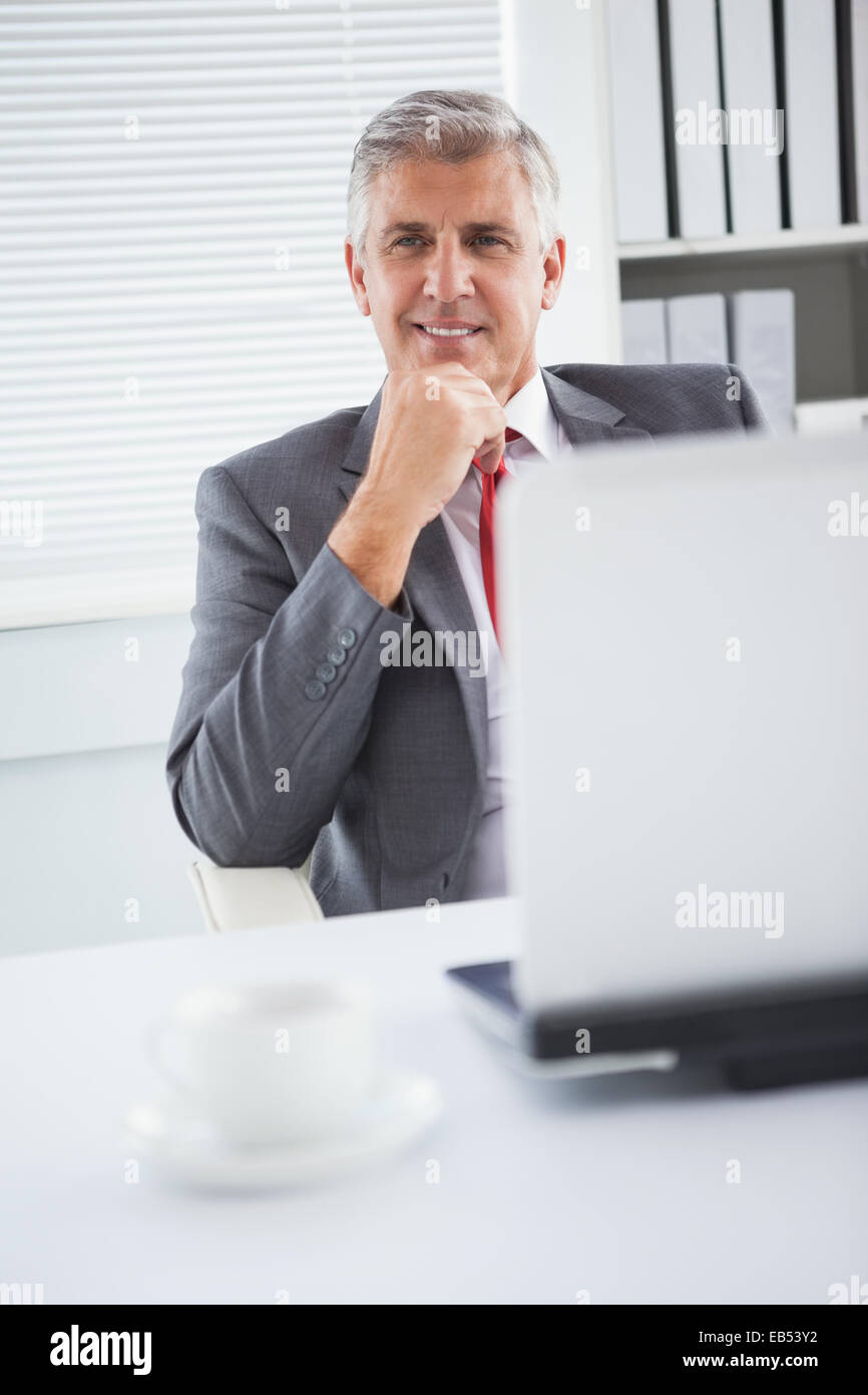 Happy businessman at his desk Stock Photo Alamy
