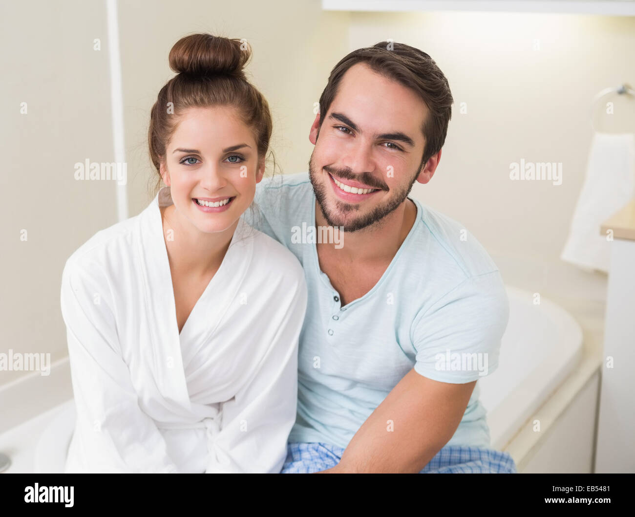 Young couple smiling at the camera Stock Photo - Alamy