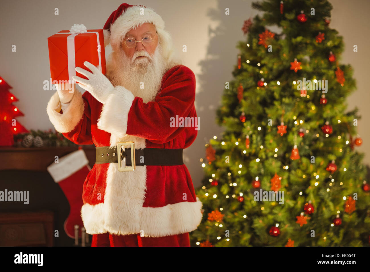 Father christmas delivering gift at christmas eve Stock Photo Alamy