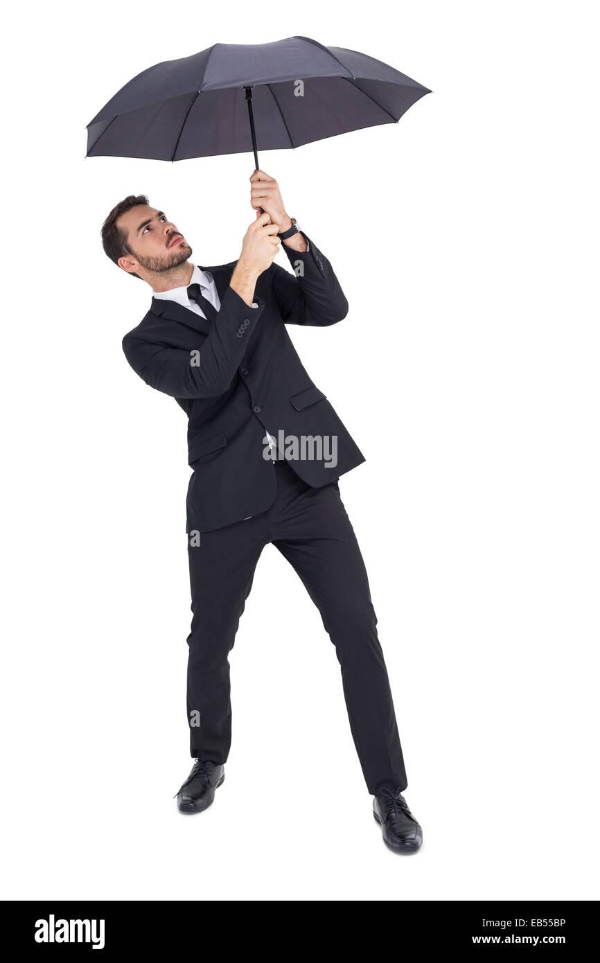 Businessman standing under black umbrella Stock Photo Alamy