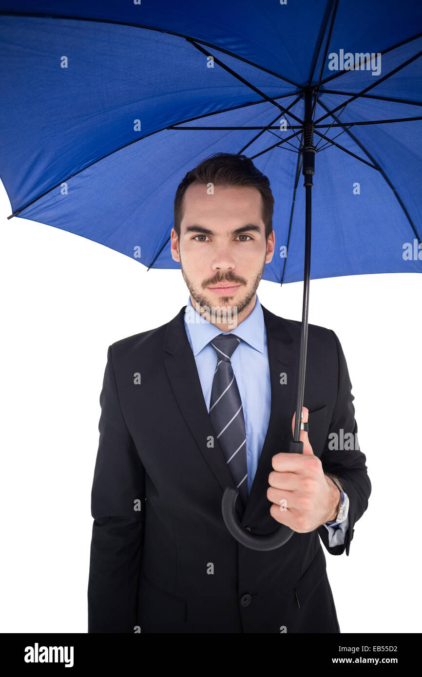Cheerful businessman standing under umbrella Stock Photo Alamy