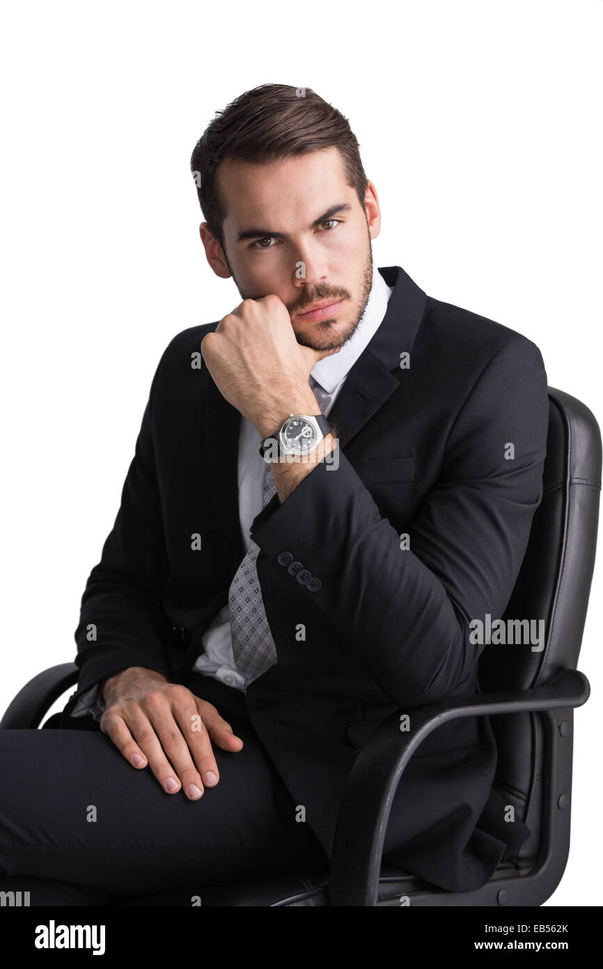 Serious businessman sitting on office chair posing Stock Photo - Alamy