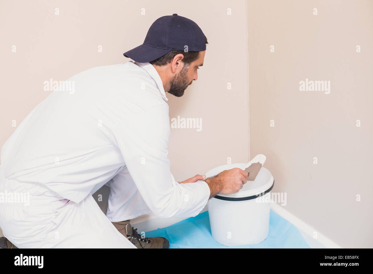 Painter painting the walls white Stock Photo Alamy