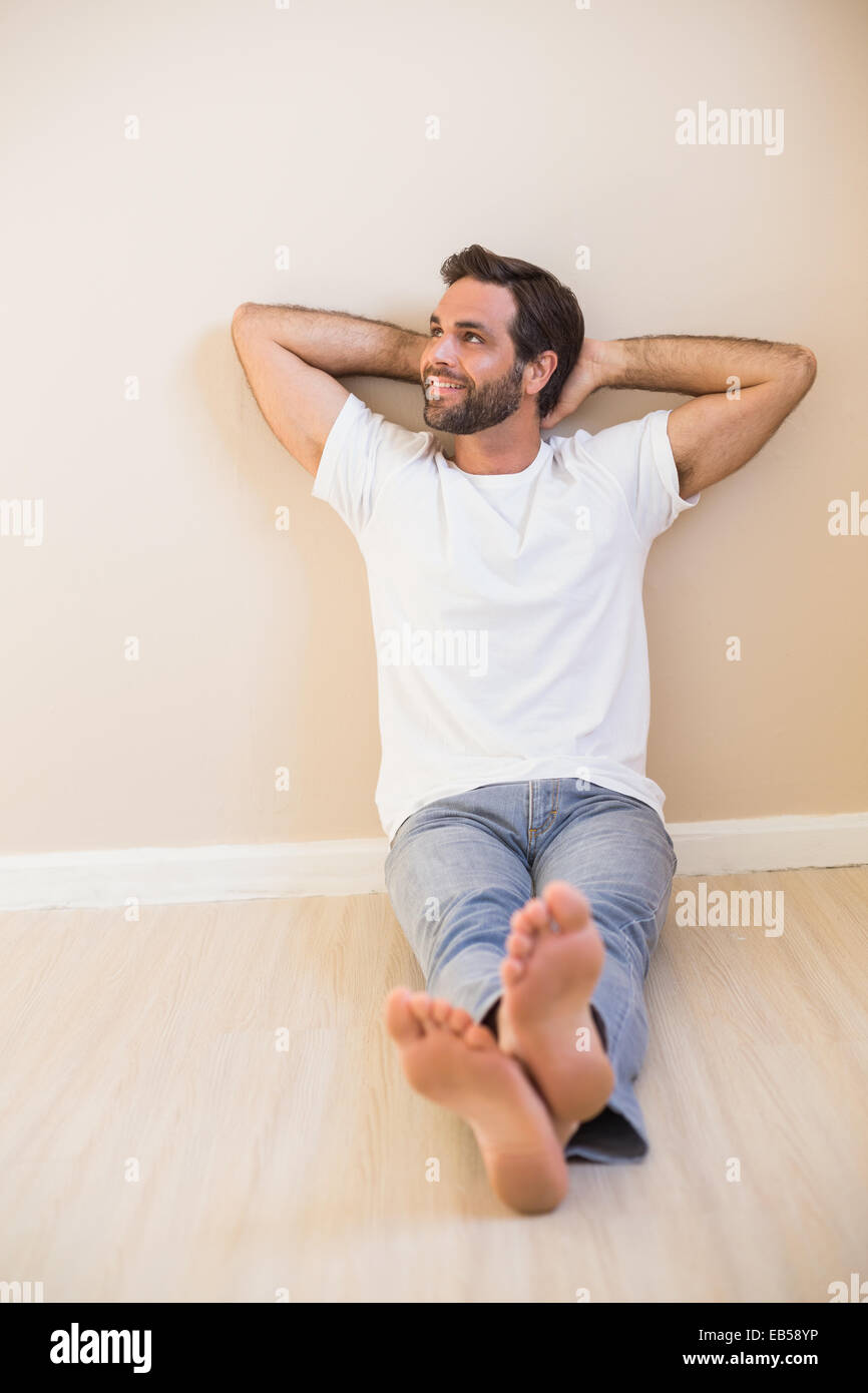 Happy man sitting on floor Stock Photo - Alamy