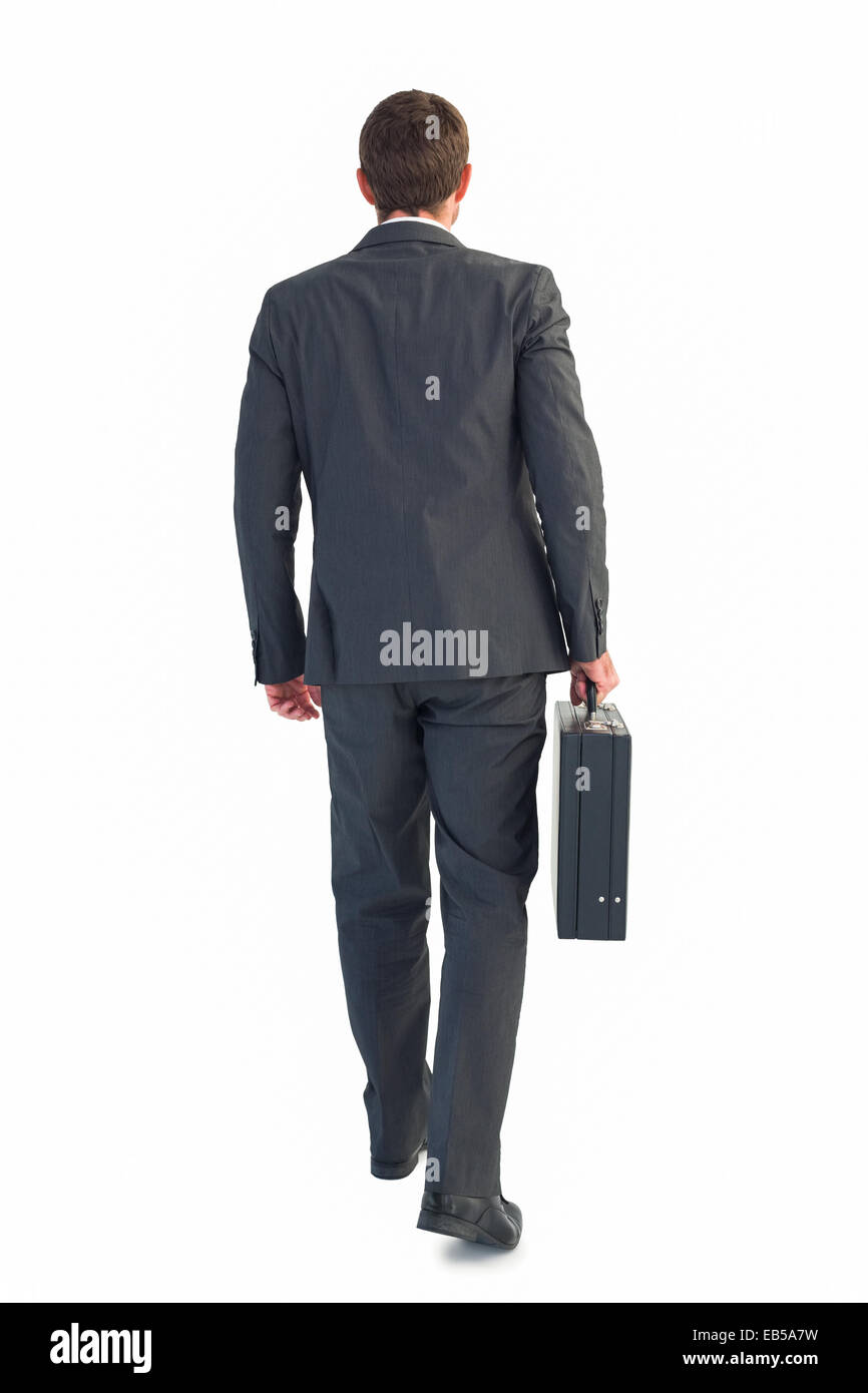 Businessman walking with his briefcase Stock Photo - Alamy