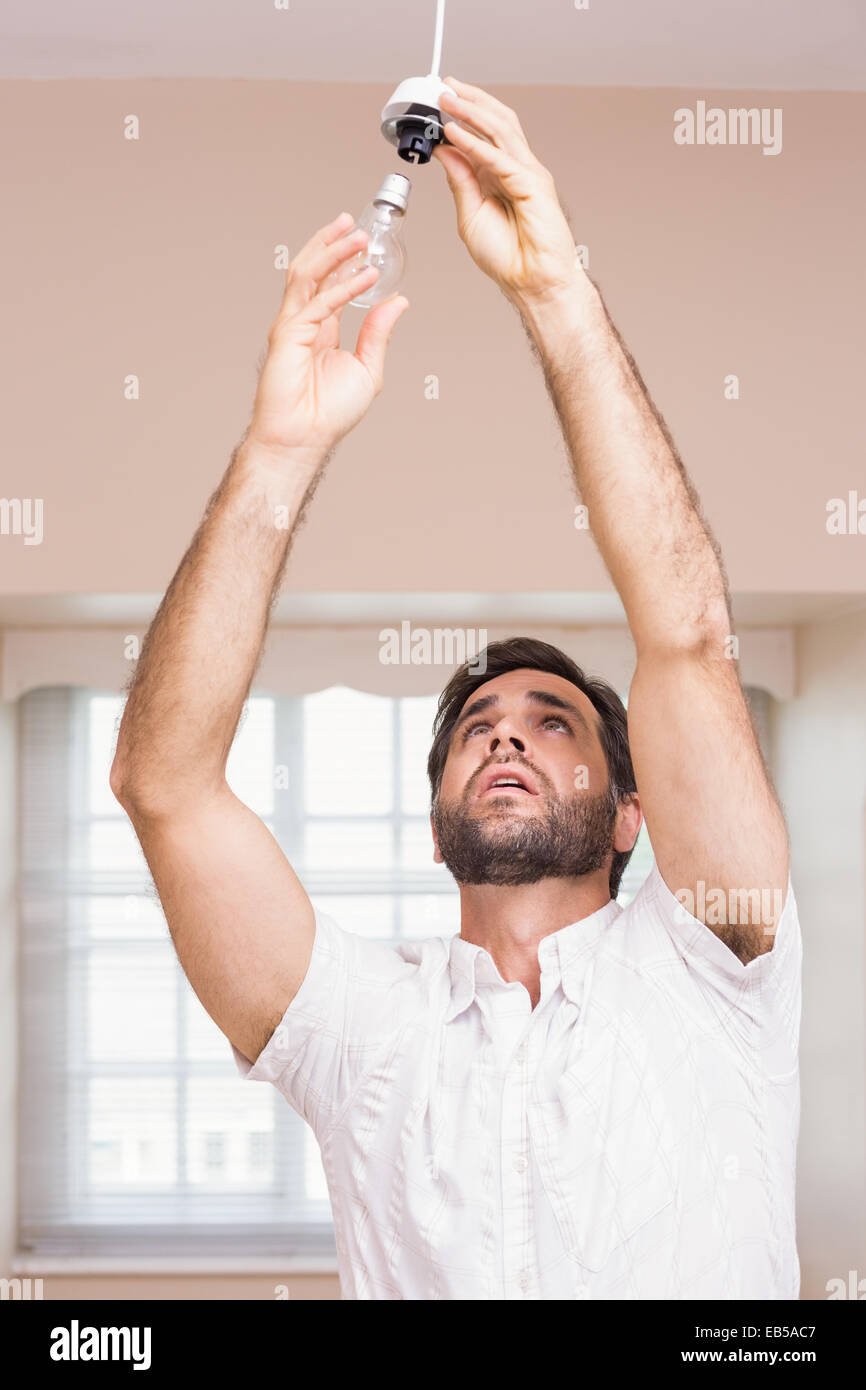 Man replacing the light bulb Stock Photo - Alamy