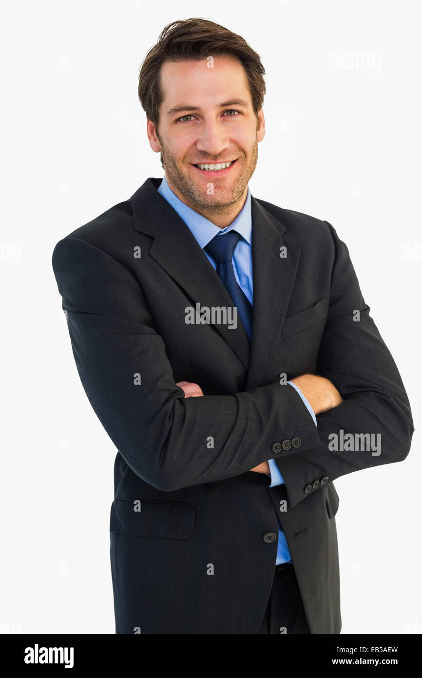 Smiling businessman with arms crossed Stock Photo - Alamy