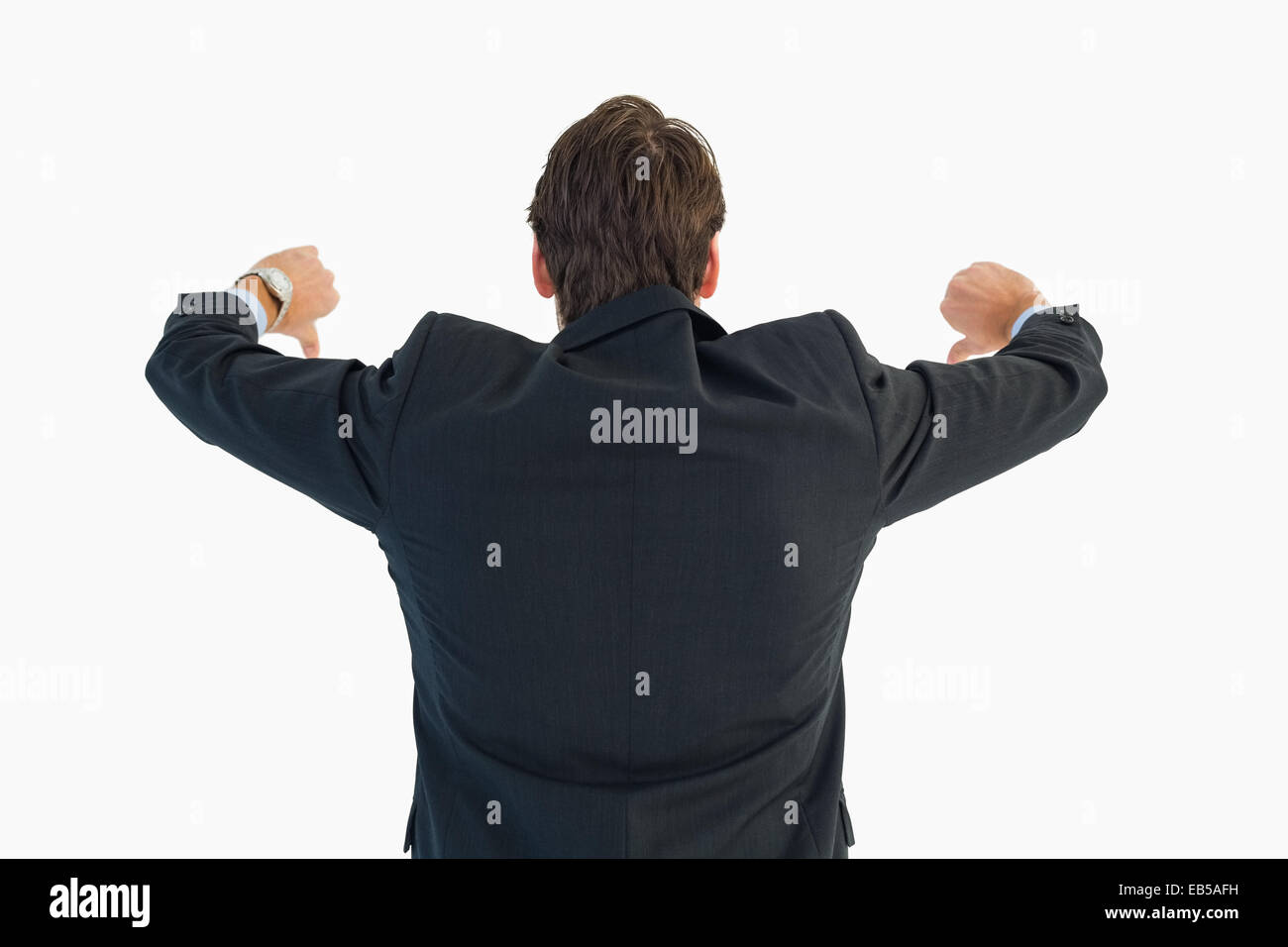 Rear view of businessman gesturing thumbs down Stock Photo - Alamy