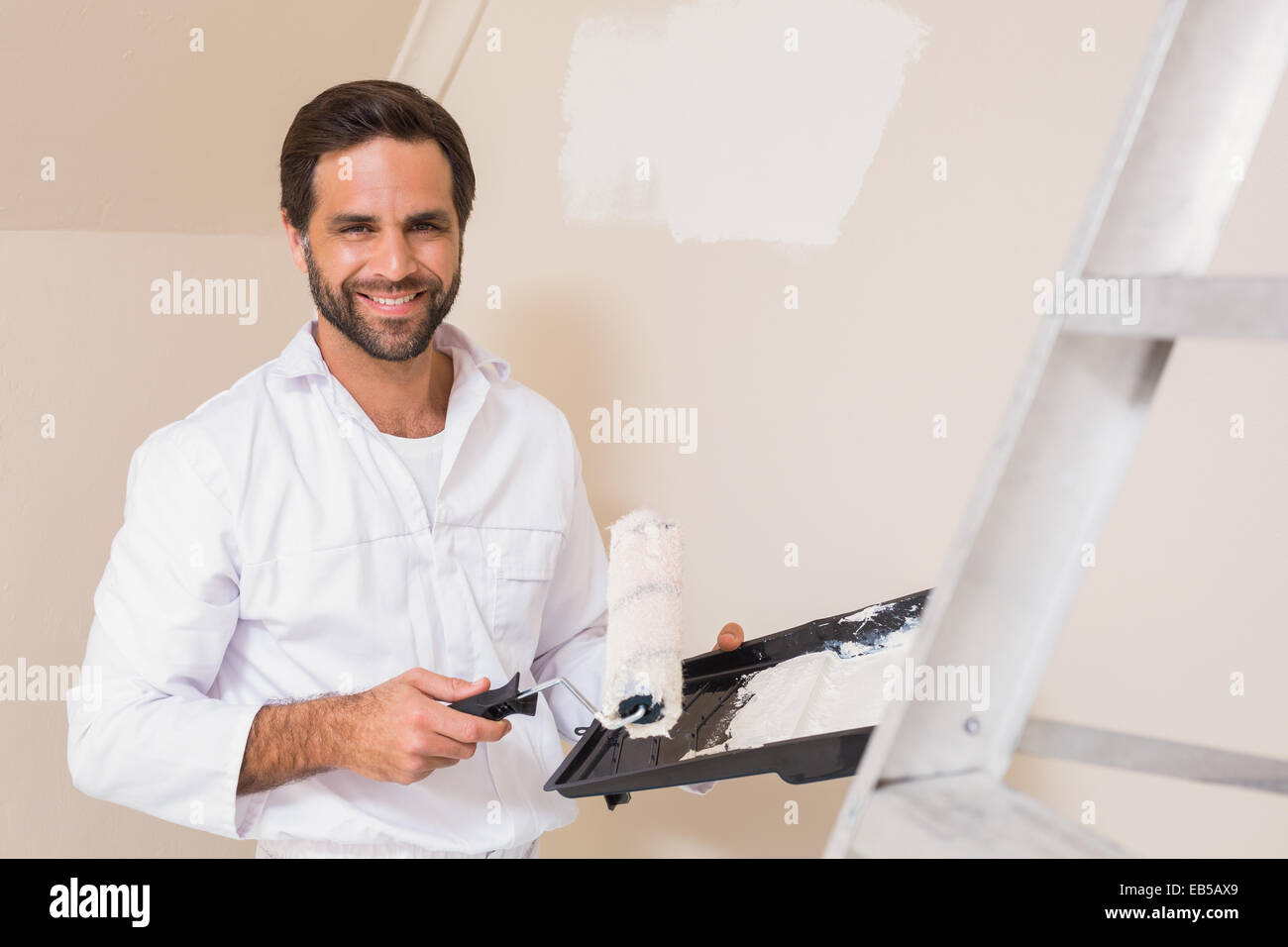 Painter painting the walls white Stock Photo Alamy