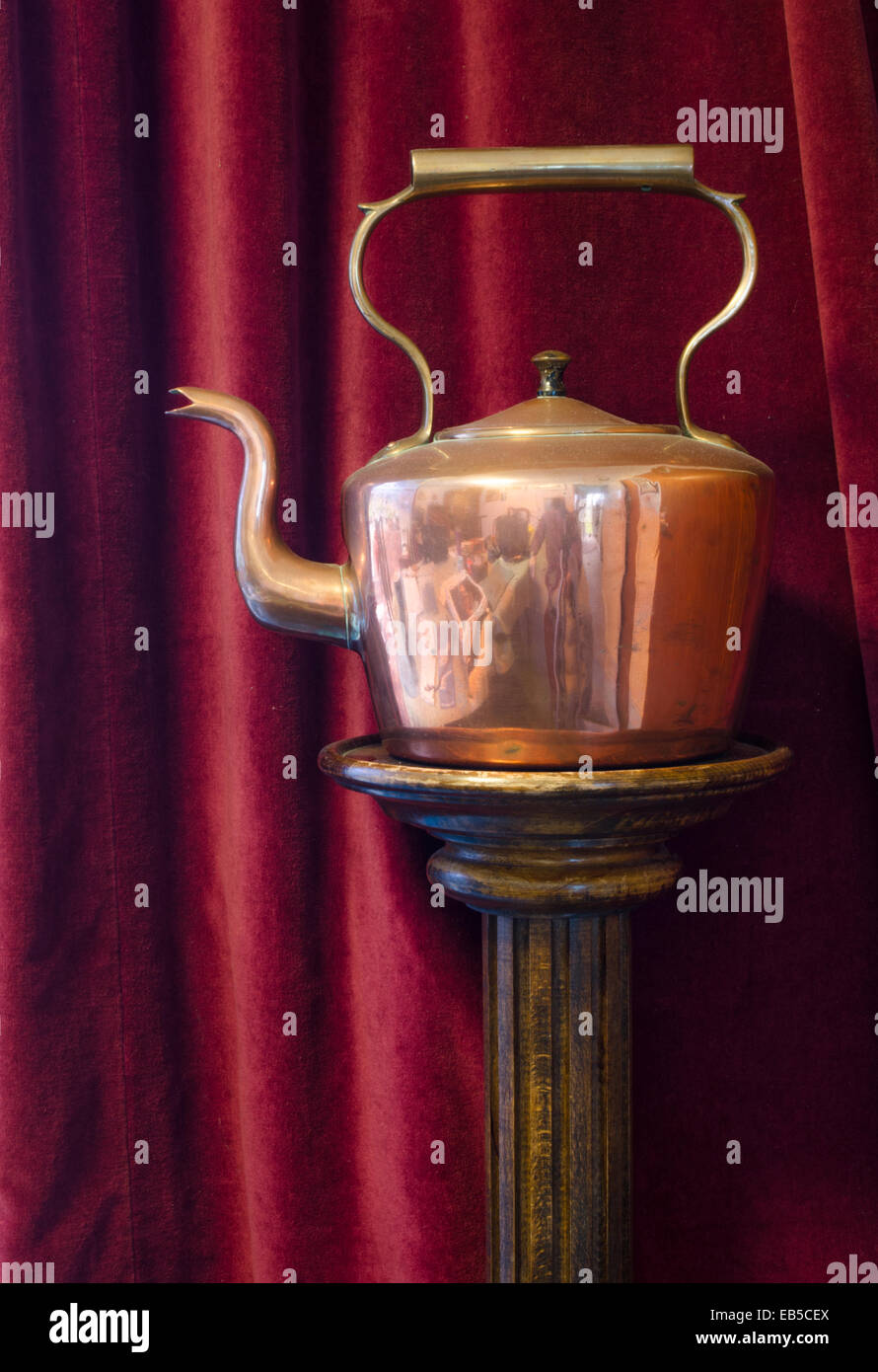 Copper kettle on wooden stand Stock Photo Alamy