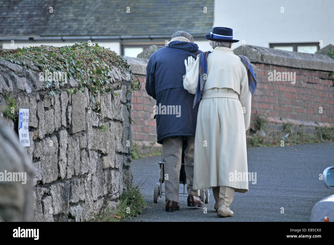 An old couple walk up a hill Stock Photo