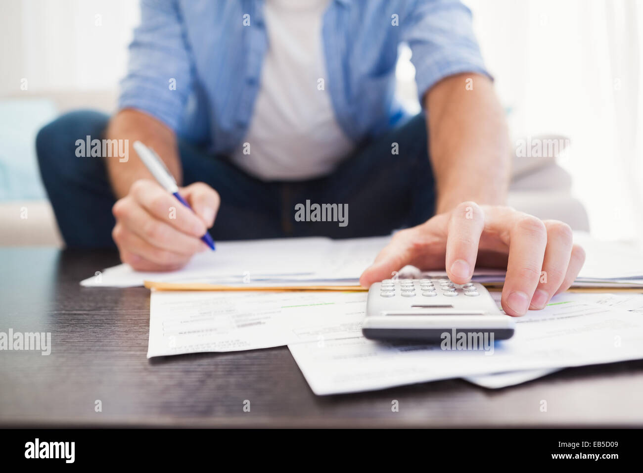 Focused man figuring out his finances Stock Photo - Alamy