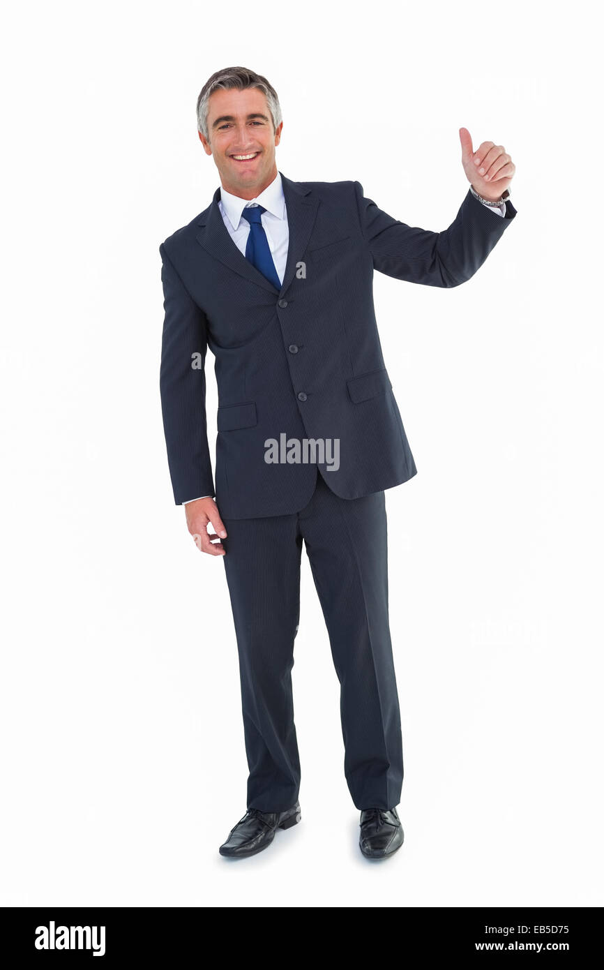 Smiling businessman posing with thumbs up Stock Photo - Alamy