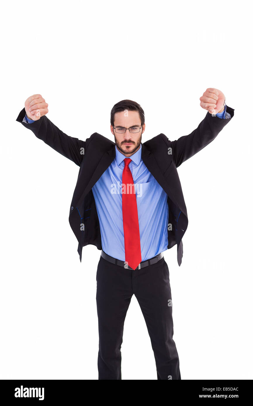 Unsmiling businessman standing with arms raised Stock Photo - Alamy