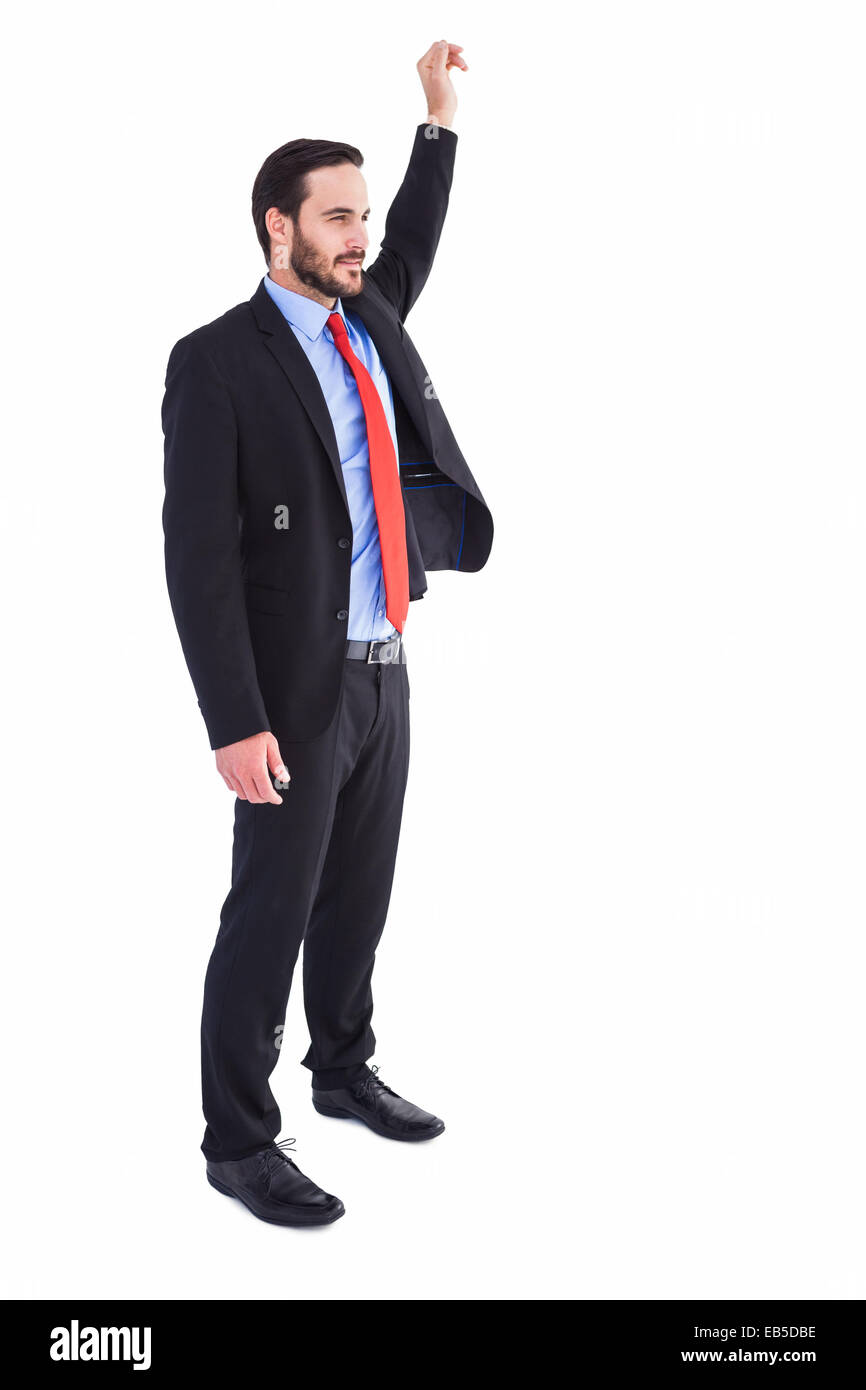 Smiling businessman standing with hand raised Stock Photo - Alamy