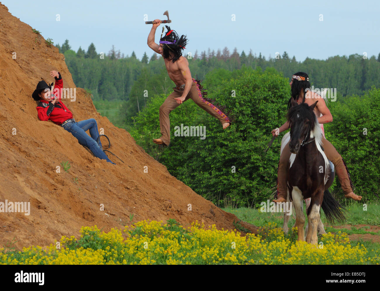 Indian warrior attacks with a tomahawk on cowboy(рarticipant role-playing game) Stock Photo