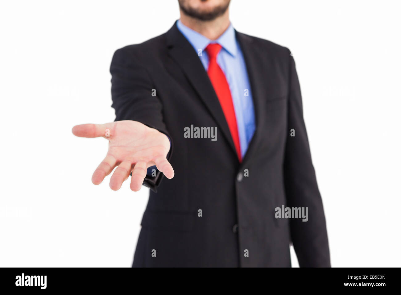 Businessman holding hand out in presentation Stock Photo - Alamy