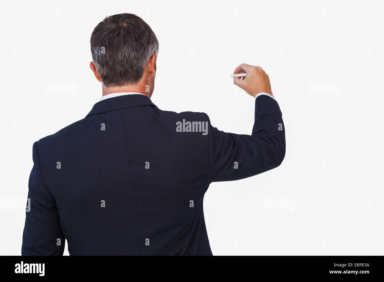 Rear view of a businessman writing with a chalk Stock Photo - Alamy
