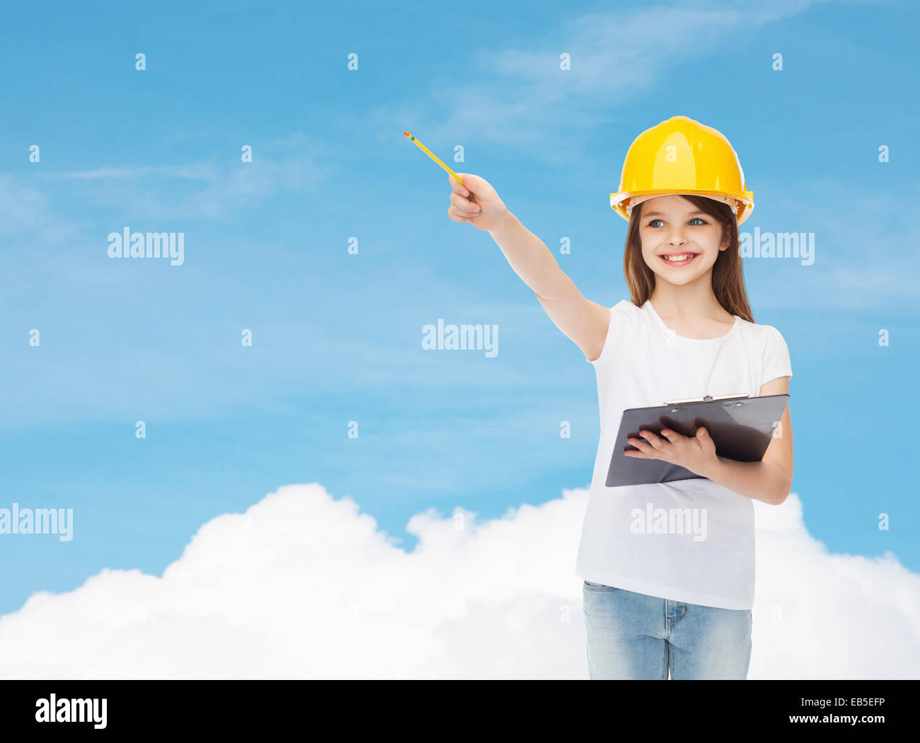 smiling little girl in hardhat with clipboard Stock Photo