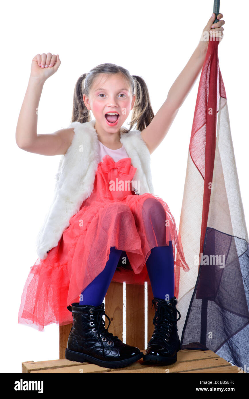 a pretty little girl sitting on a box with a french flag on the white background Stock Photo