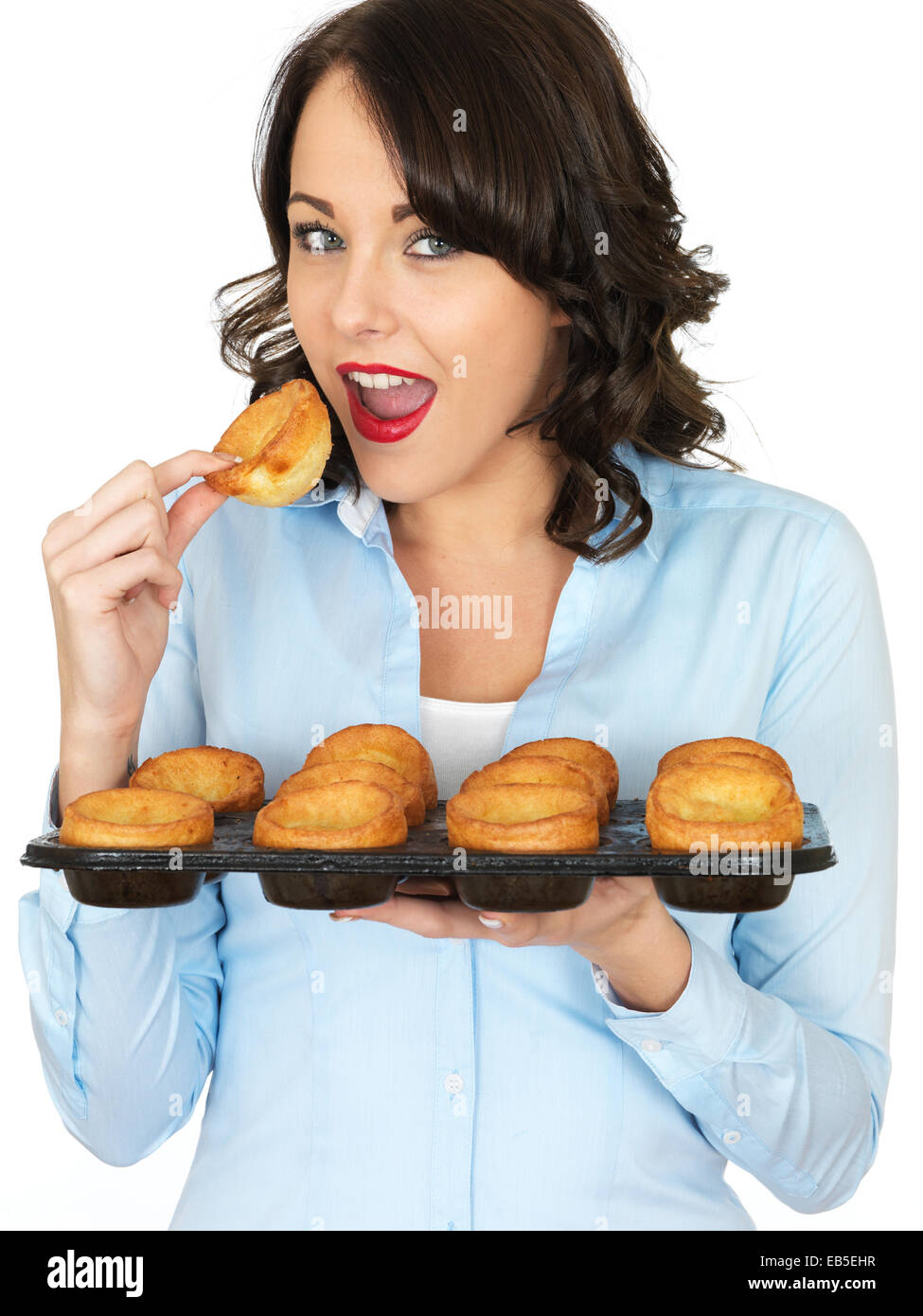 Young Woman Holding A Tray Of Freshly Cooked Traditional Yorkshire