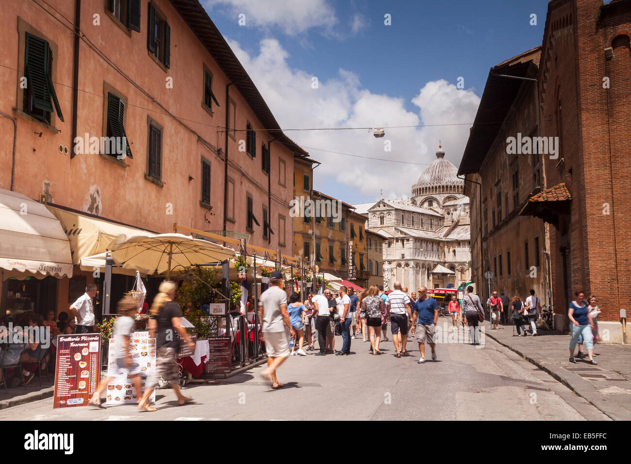 Via Santa Maria in Pisa, Italy. The Duomo di Pisa is seen at the end of the street. Stock Photo
