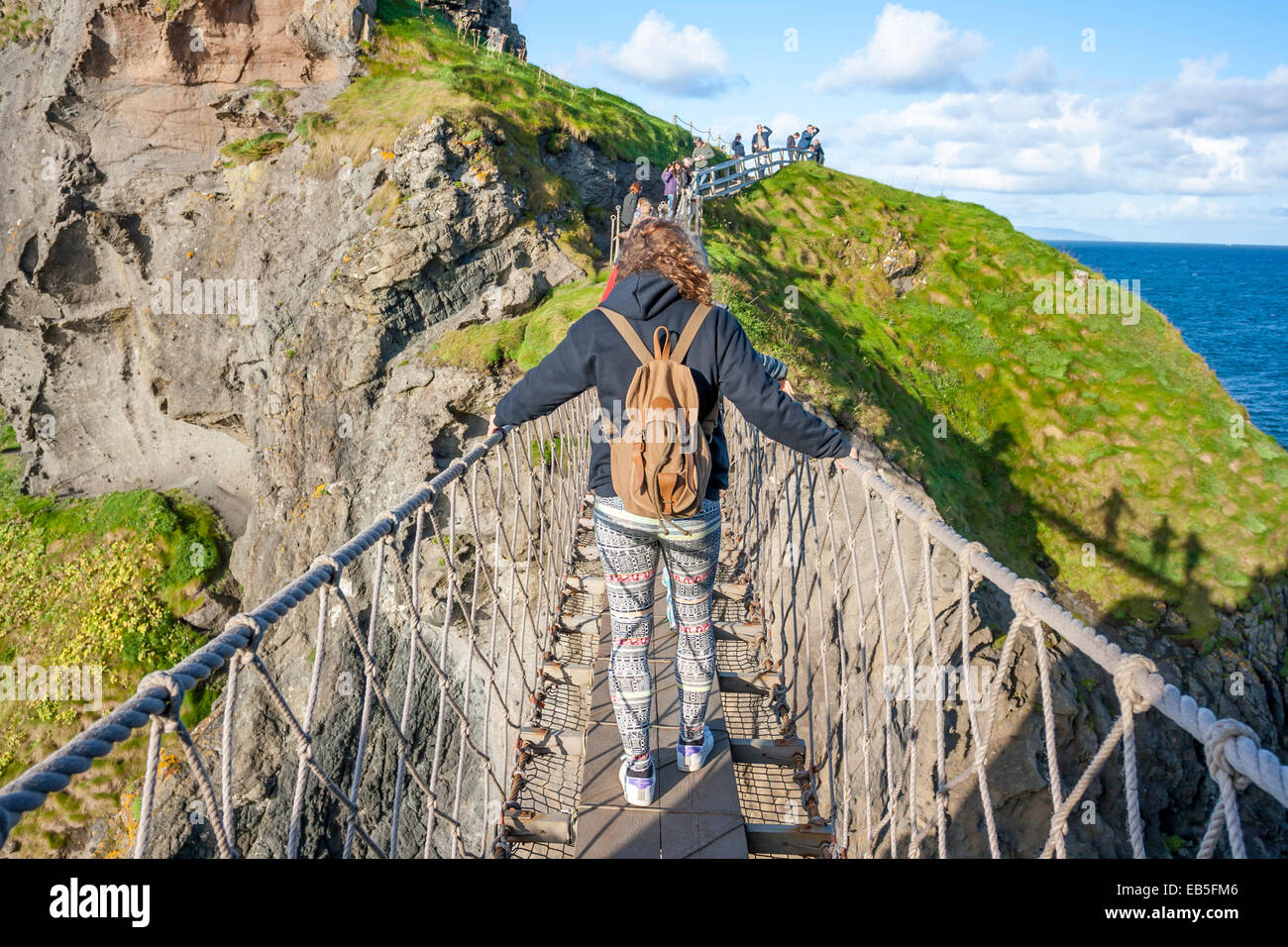 Belfast, Northern Ireland - Aug 19, 2014: People crossing the Rope Bridge: Carrick a rede in North Antrim, Northern Ireland on A Stock Photo