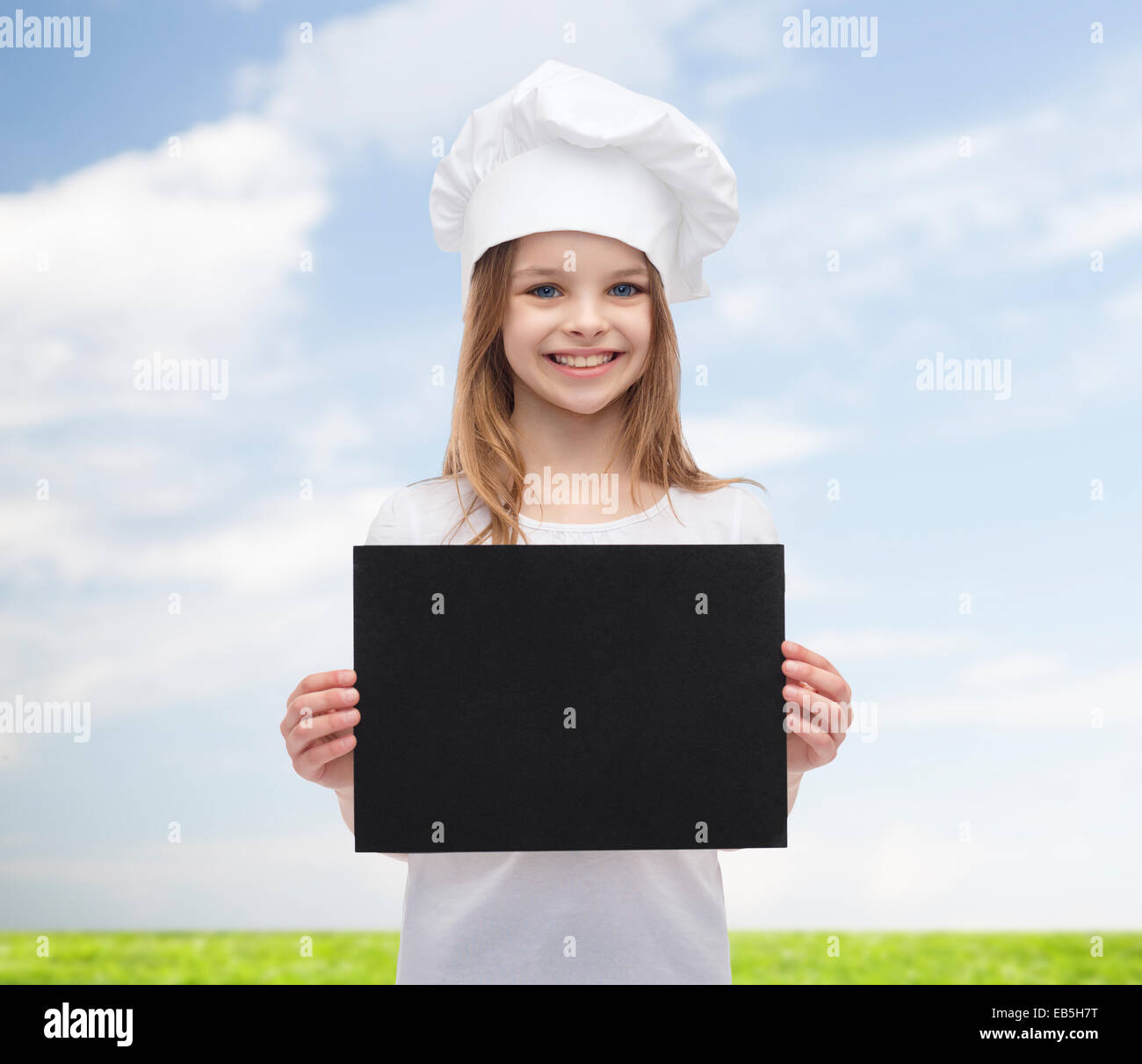 little cook or baker with blank black paper Stock Photo