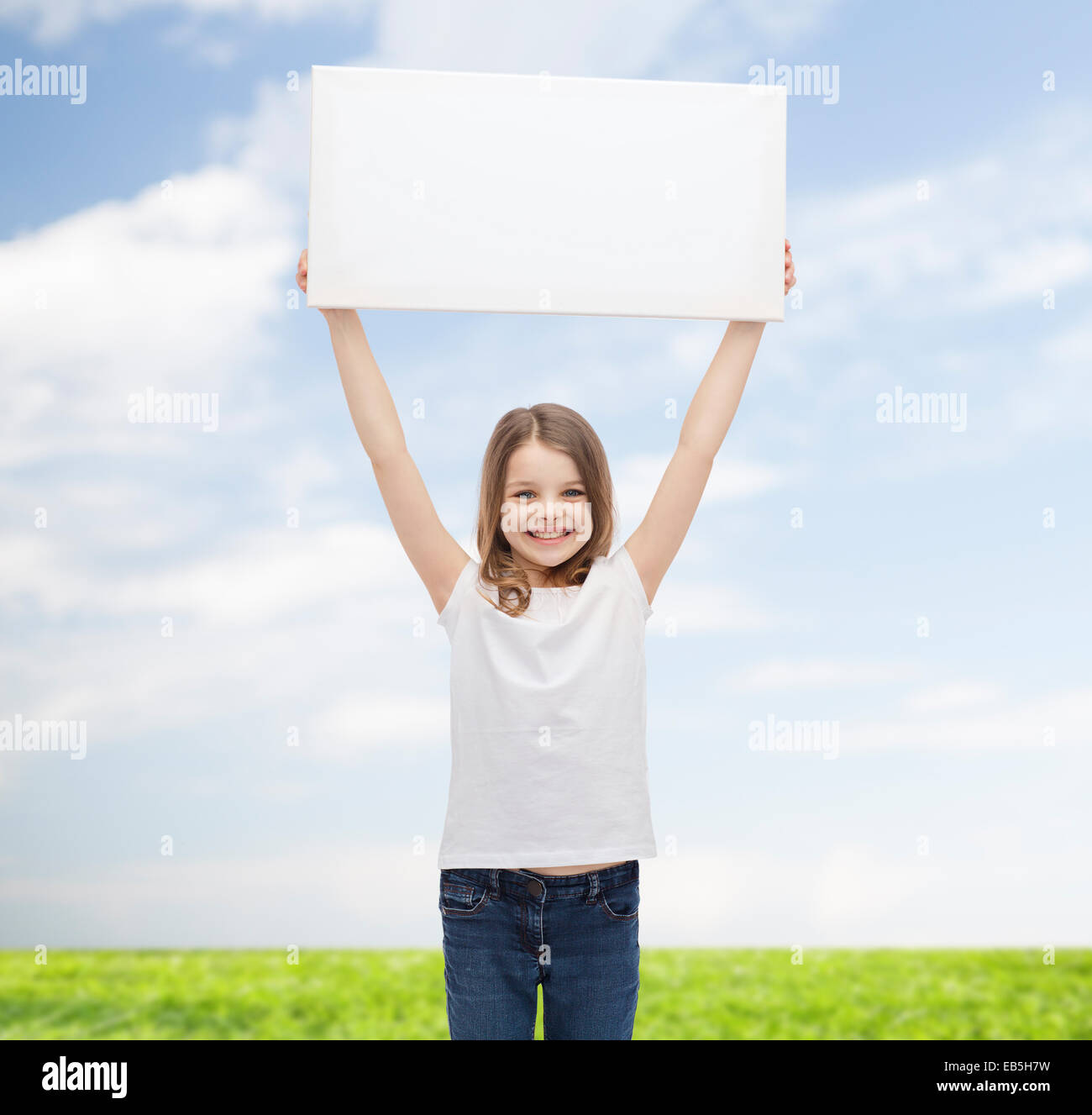 smiling little girl holding blank white board Stock Photo - Alamy