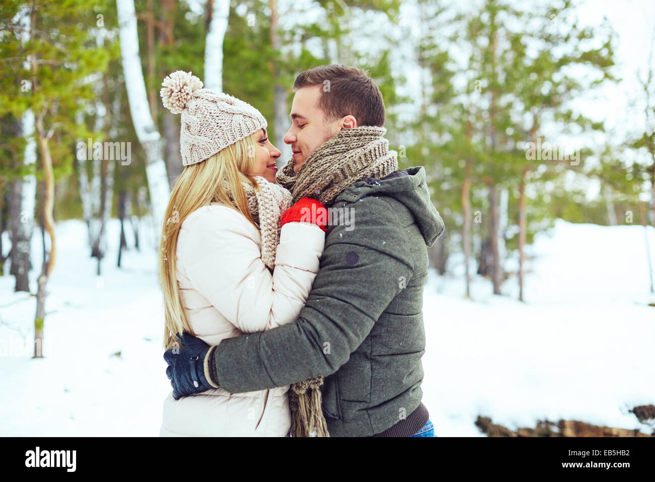 Young couple embracing in winter park Stock Photo - Alamy