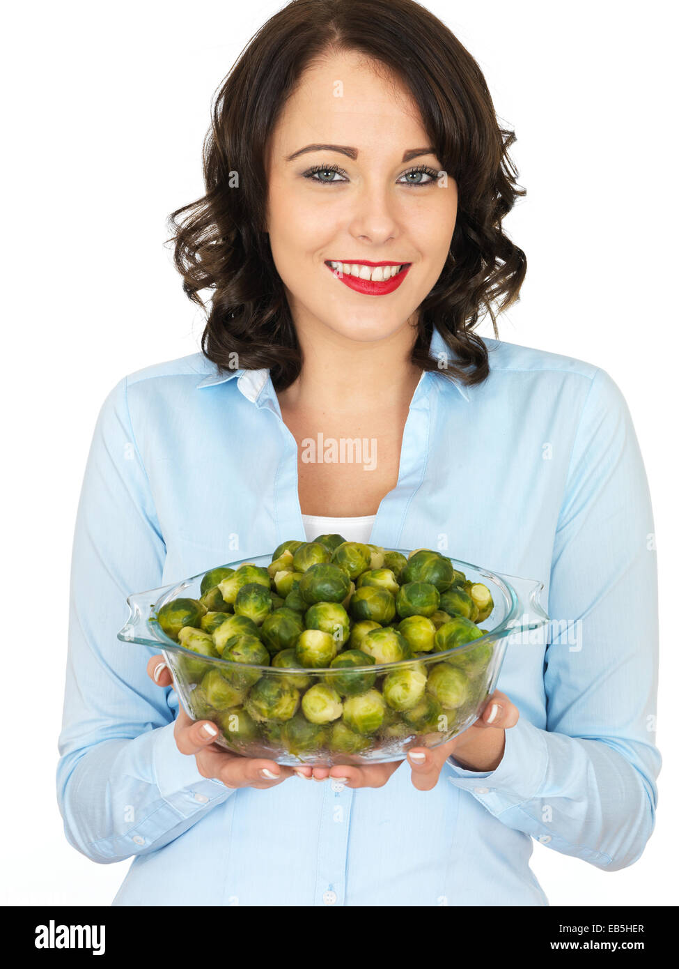 Young Woman Holding A Bowl Of Freshly Cooked Brussel Sprouts Vegetables Isolated Against A White Background Ready To Eat With A Clipping path Stock Photo