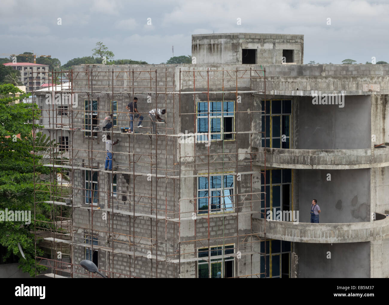 Construction of concrete block apartment building with expat supervisor