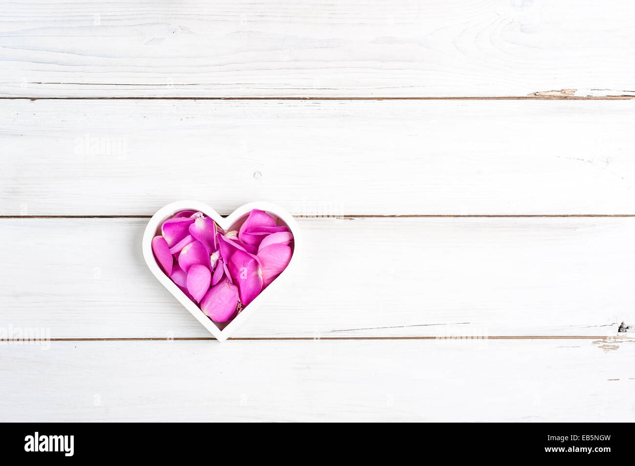 Bright Pink Rose Petals In A Heart Shaped White Bowl On A White Slatted Wooden Board Stock Photo Alamy