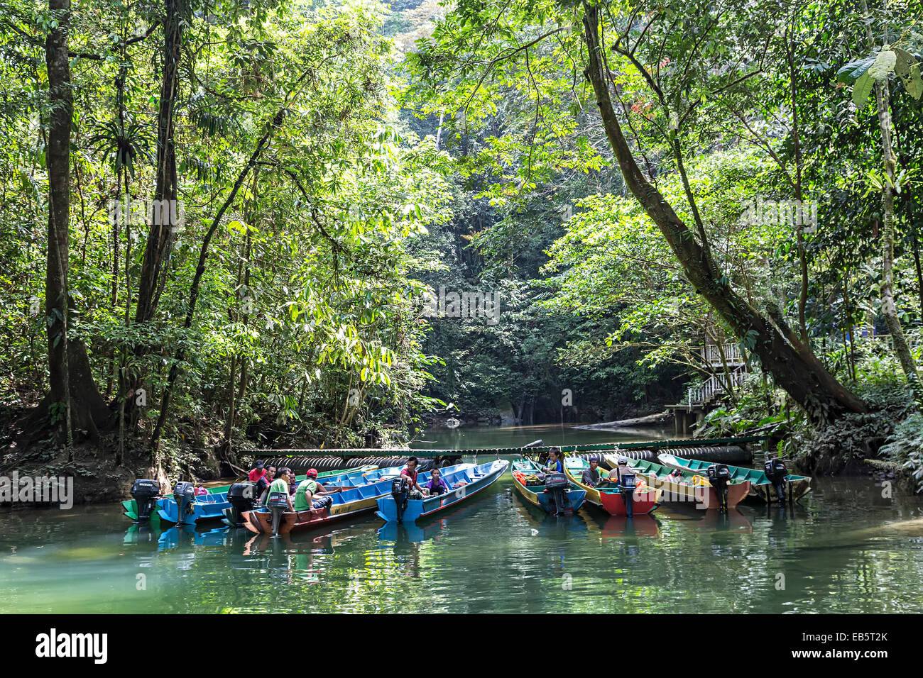 Boats moored at landing stage, Clearwater Cave, Mulu, Malaysia Stock Photo