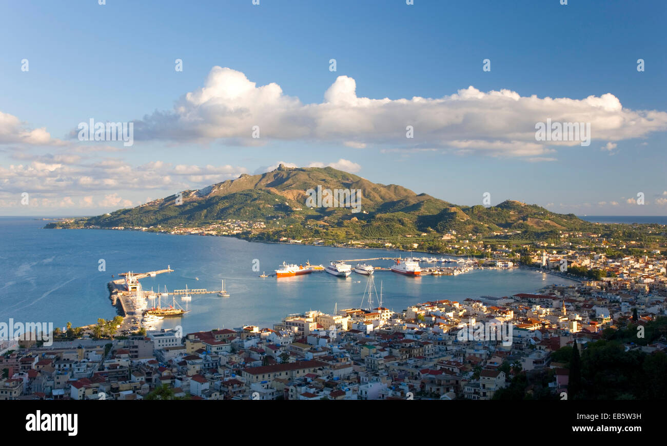 Zakynthos Town, Zakynthos, Ionian Islands, Greece. View from Bochali over city rooftops to the harbour and Vasilikos Peninsula. Stock Photo