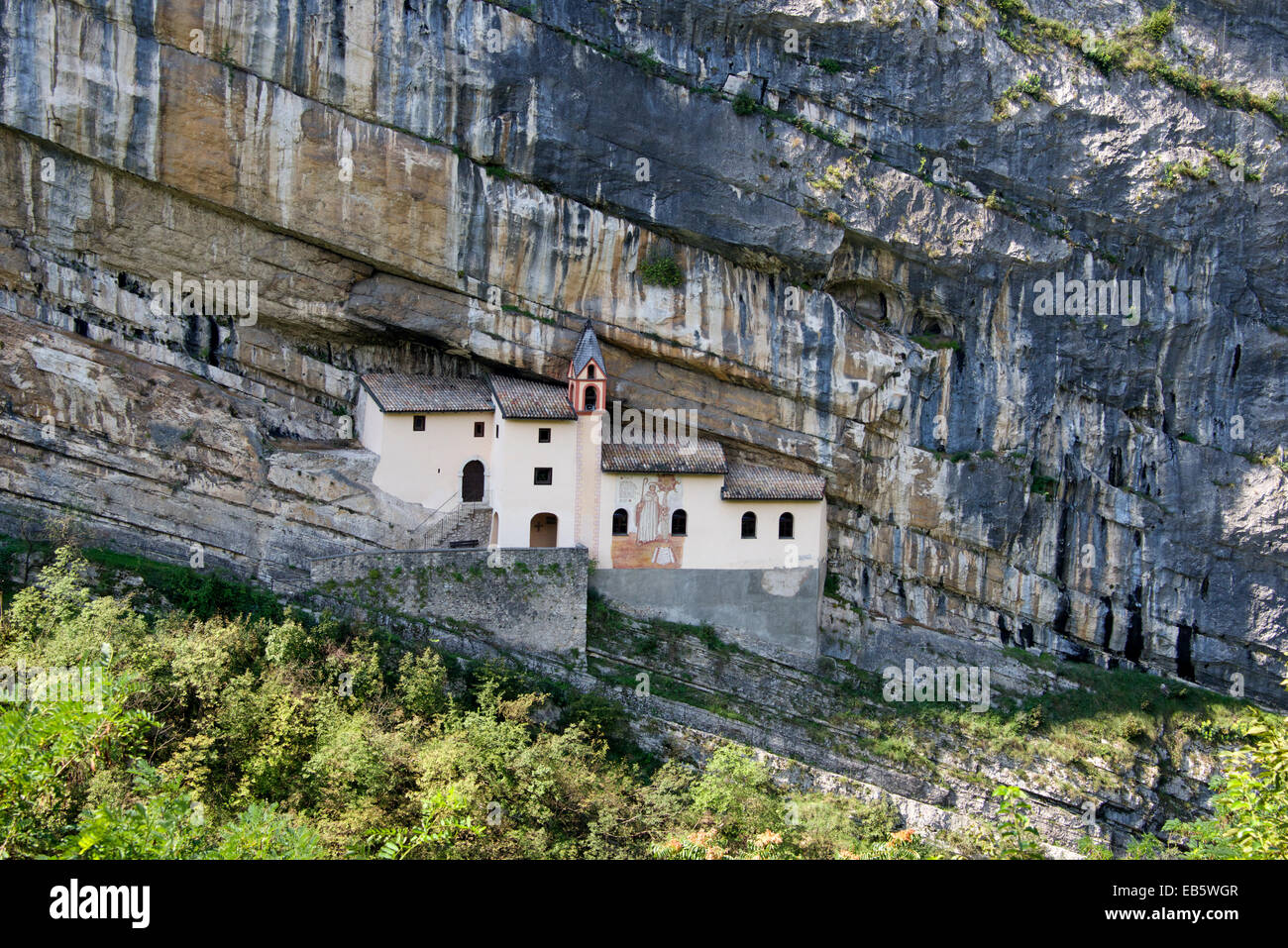 Hermitage of San Colombano built in cliff face Trambileno Trentino Northern Italy Stock Photo