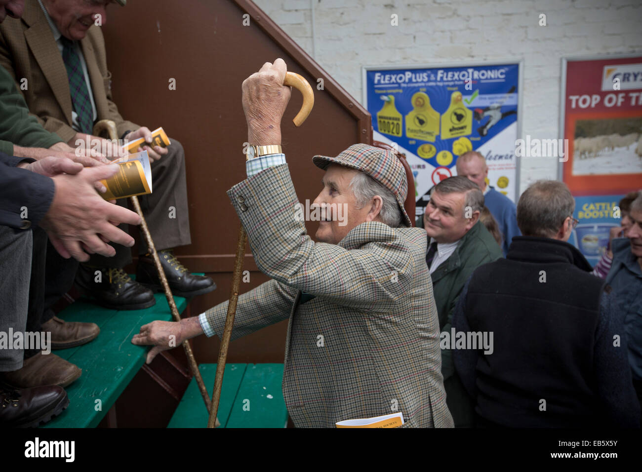 A man with traditional tweed jacket, deerstalker hat and a crook in conversation at the Dalmally Agricultural Show, Scotland. Stock Photo