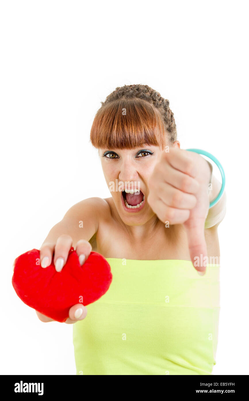 Angry teenage woman being hurt and heart broken suffers , Love hurts ,  Miserable girl squeezing heart Stock Photo