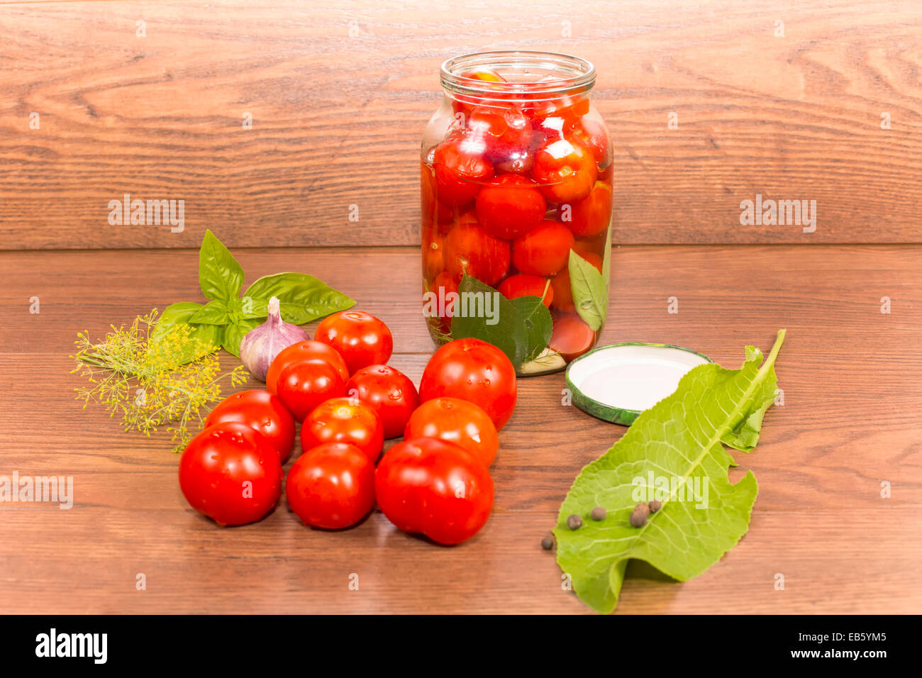 canning tomatoes in glass jars with spices Stock Photo Alamy