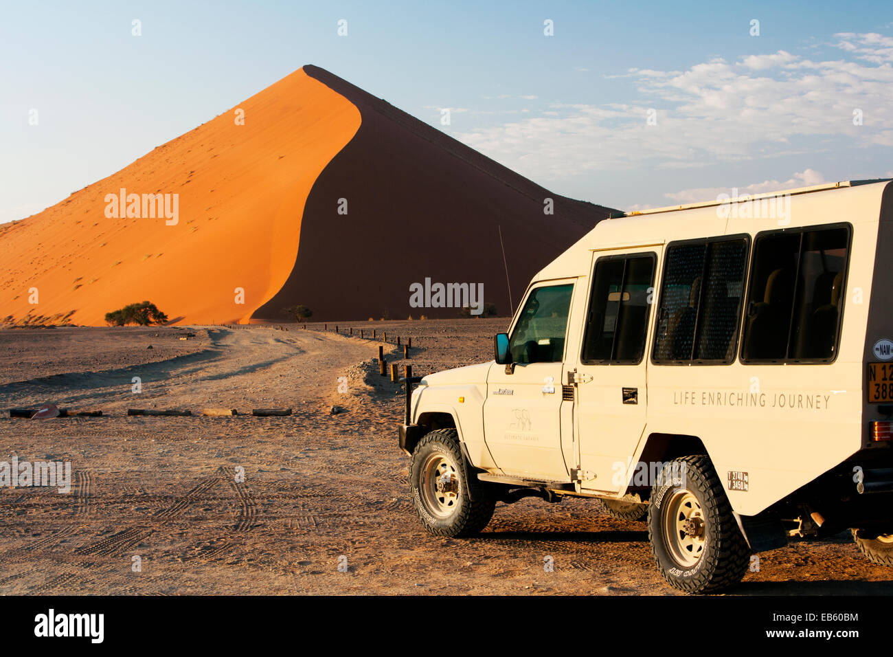 Safari Vehicle and Sand Dune in Sossusvlei National Park - Namib-Naukluft National Park, Namibia, Africa Stock Photo