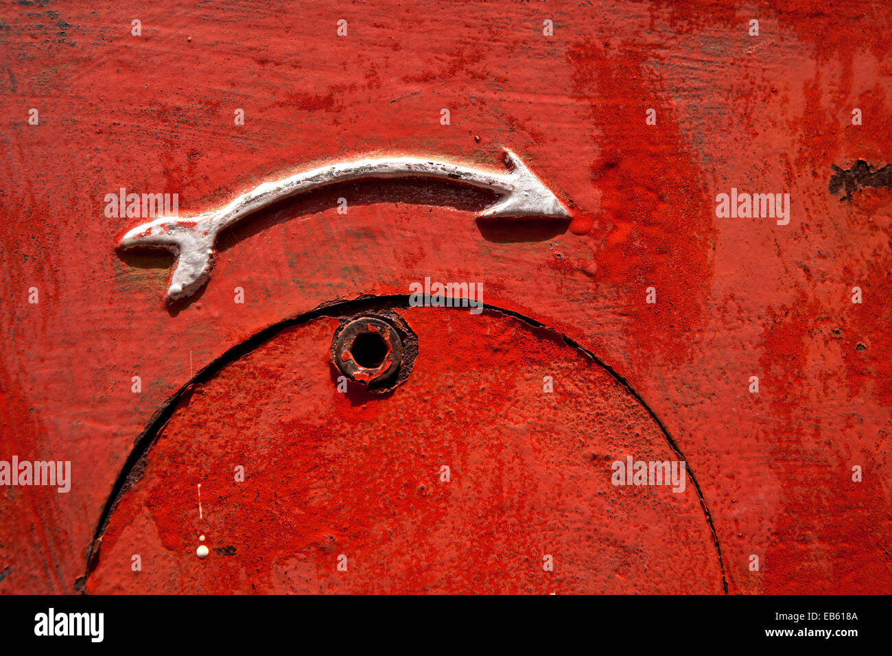 Metallic Arrow on red background - Solitaire - Khomas Region, Namibia, Africa Stock Photo