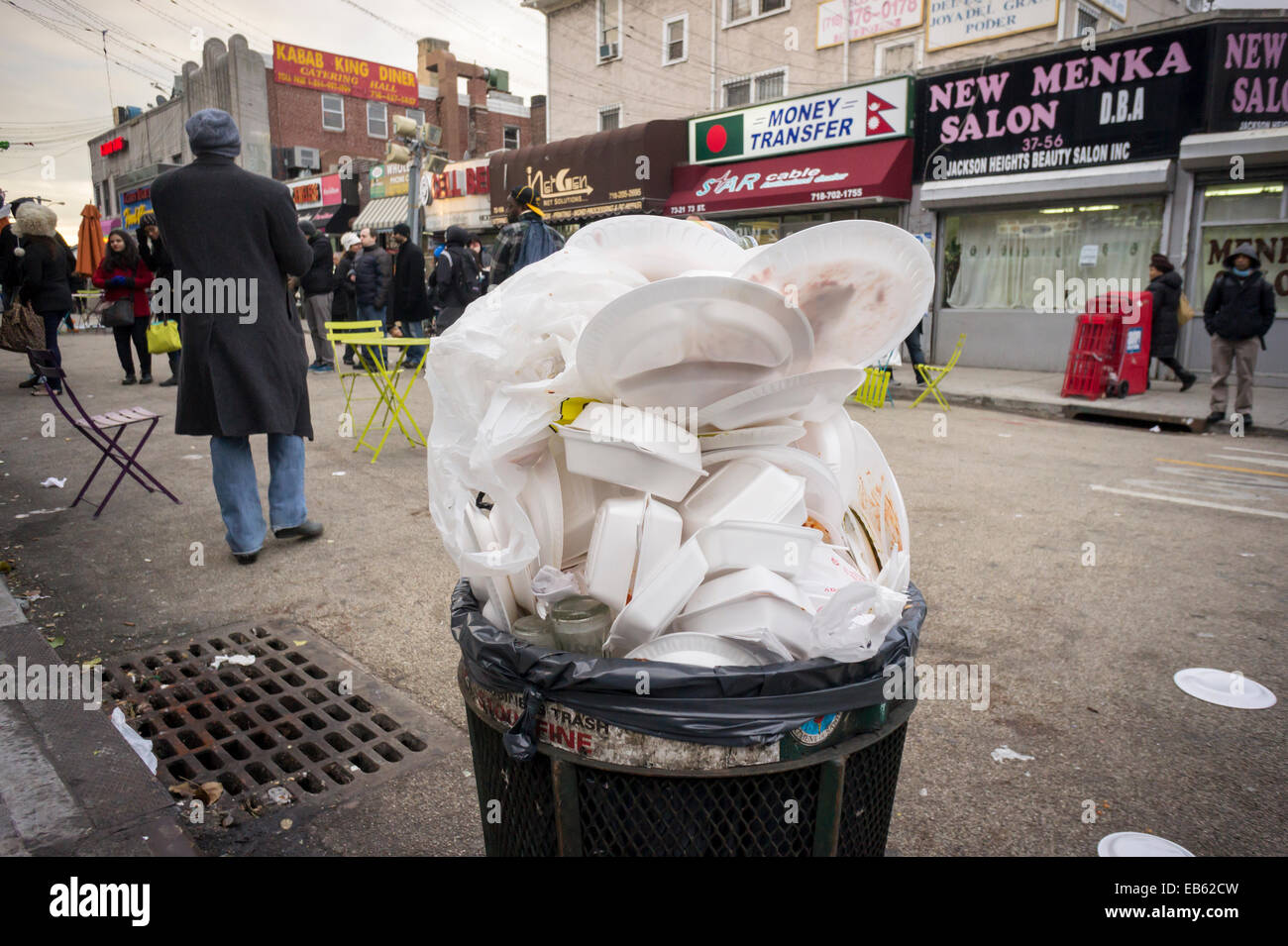 An overflowing trash can, filled mostly with styrofoam packaging,  is seen in Diversity Plaza in Jackson Heights, New York Stock Photo