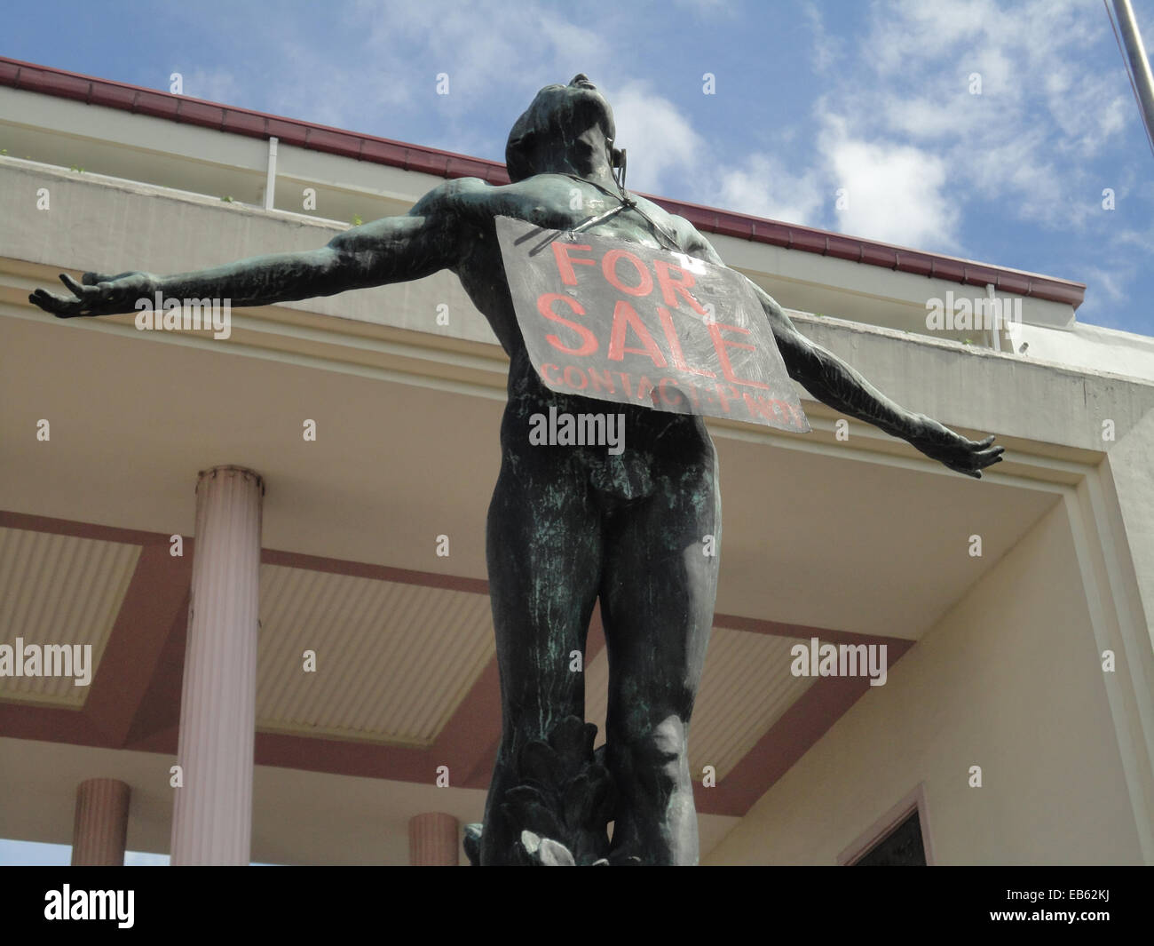 A sign that reads "For Sale, Contact PNoy" hangs around the neck of