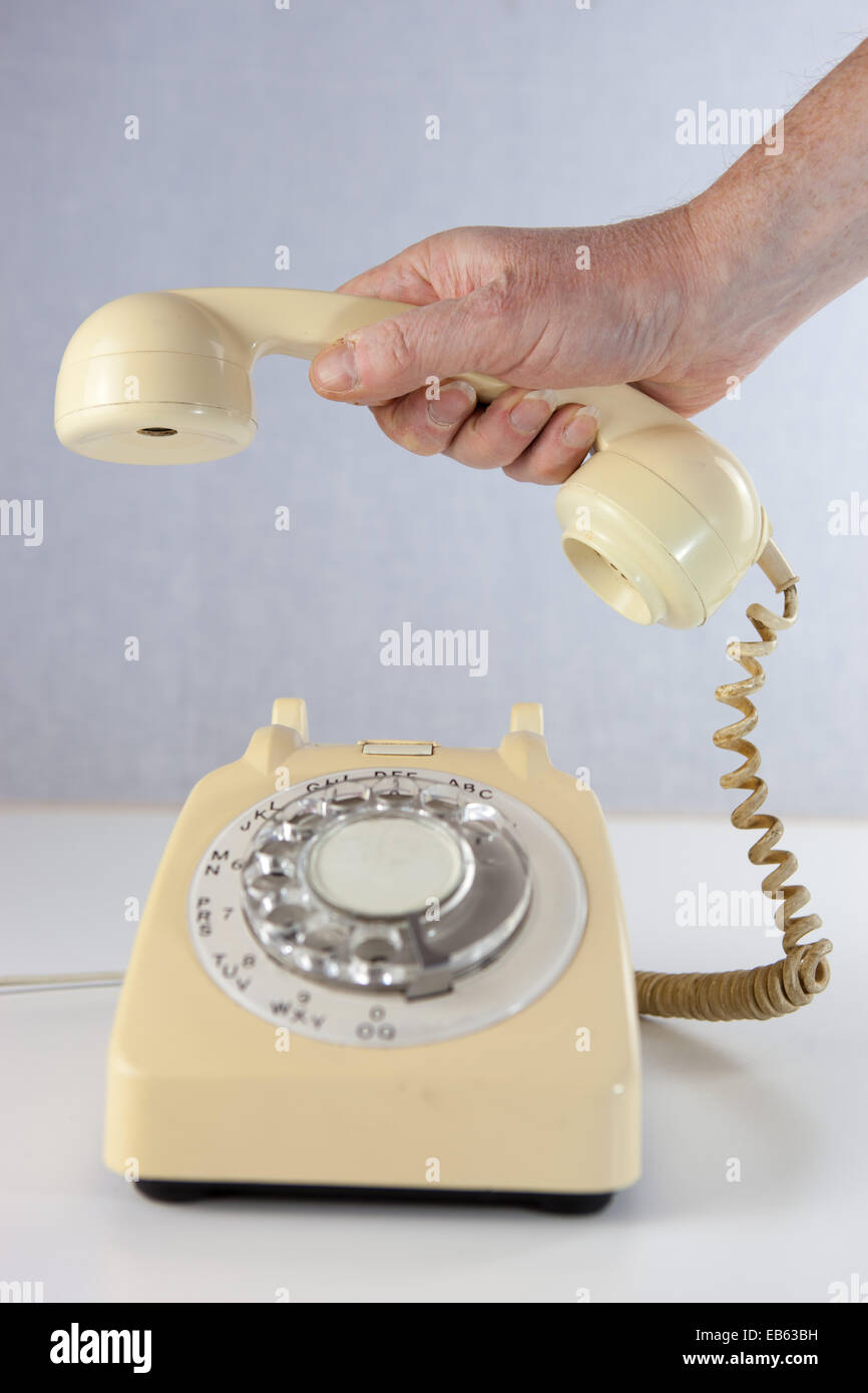 https://c8.alamy.com/comp/EB63BH/answering-an-old-fashioned-rotary-dial-telephone-EB63BH.jpg