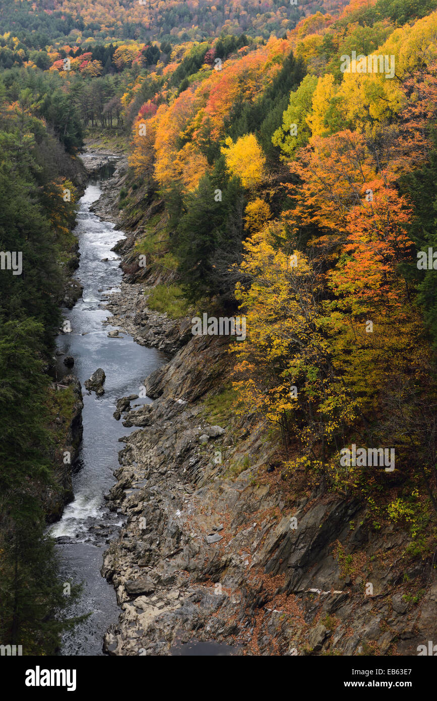 Bright Fall foliage on the Ottauquechee river at the deep Quechee Gorge Vermont Stock Photo