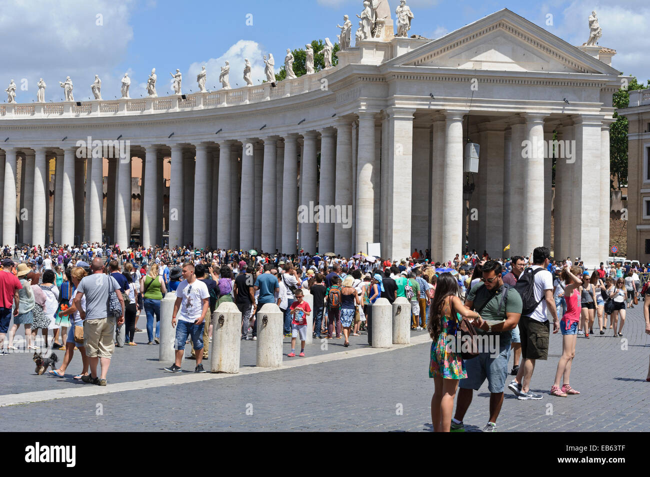 Tourists visiting the iconic square with its huge white columns and ...